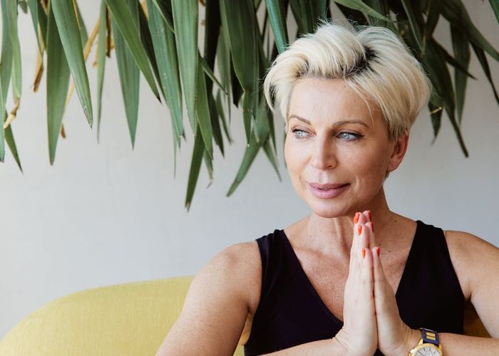 Person meditating peacefully after a workout session with soft lighting.